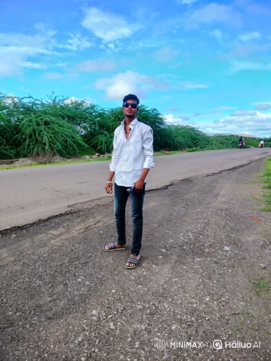 Young Man Stands on Rural Road Amidst Gentle Breeze – AI Generated Video | Hailuo AI