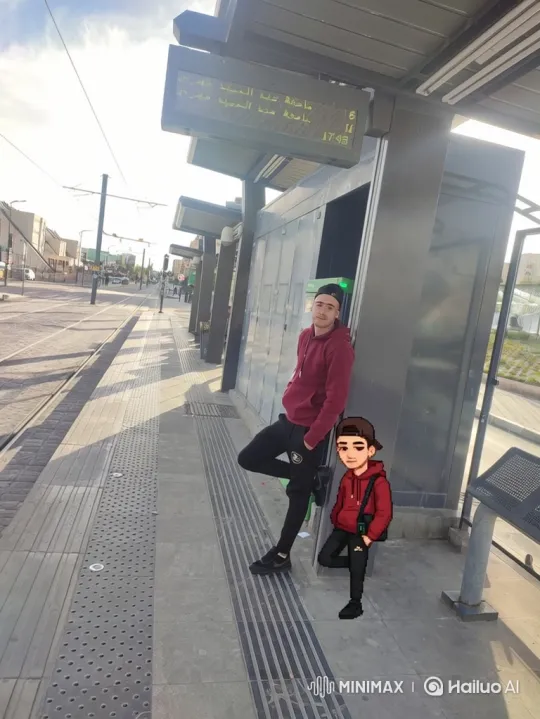Young Man and Cartoon Figure on Tram Platform – AI Generated Video | Hailuo AI