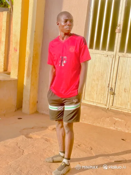 Young Black Man Stands in Sunlit Courtyard – AI Generated Video | Hailuo AI