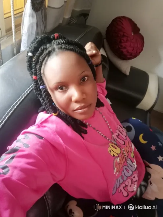 Woman in Vibrant Pink Sweatshirt on Black Couch – AI Generated Video | Hailuo AI