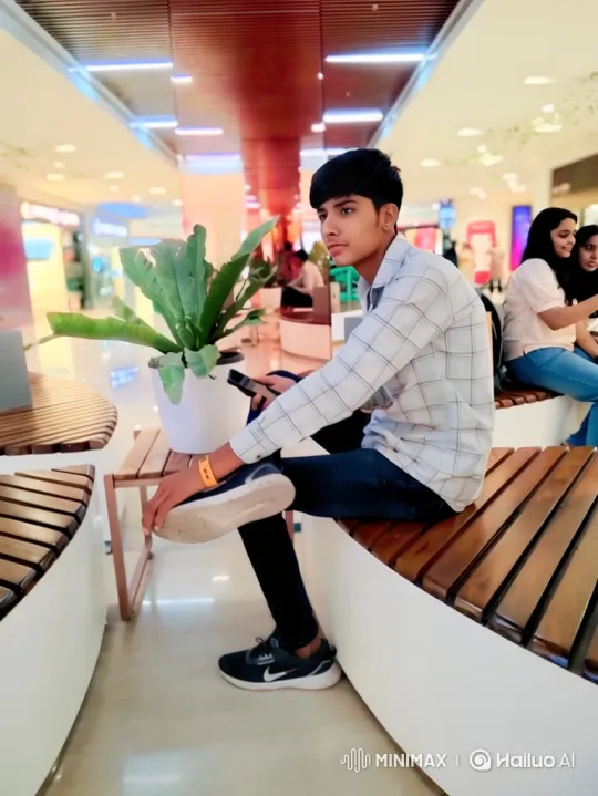 Thoughtful Young Man on Bench in Modern Mall – AI Generated Video | Hailuo AI