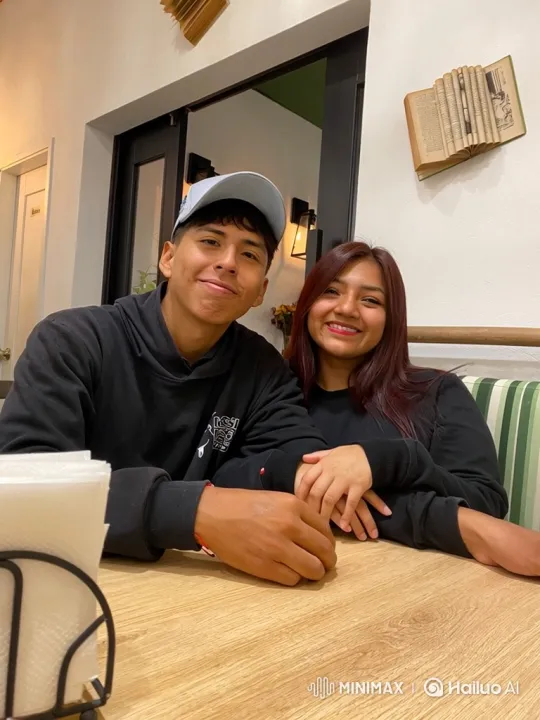 Family Embrace in a Cozy Café – AI Generated Video | Hailuo AI