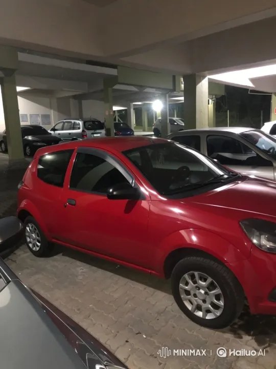Red Hatchback Lowering in Covered Parking Garage – AI Generated Video | Hailuo AI