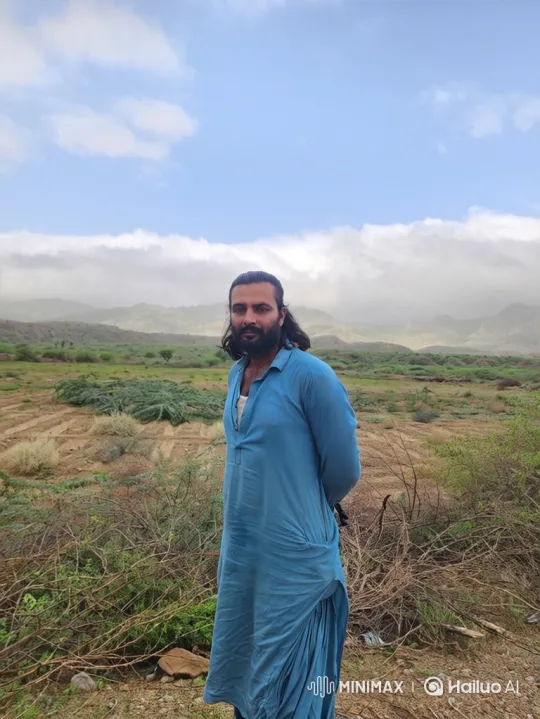 Contemplative Man in Open Landscape with Rolling Hills – AI Generated Video | Hailuo AI