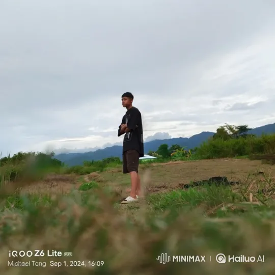 Contemplative Man on Hill Amidst Gentle Breeze – AI Generated Video | Hailuo AI