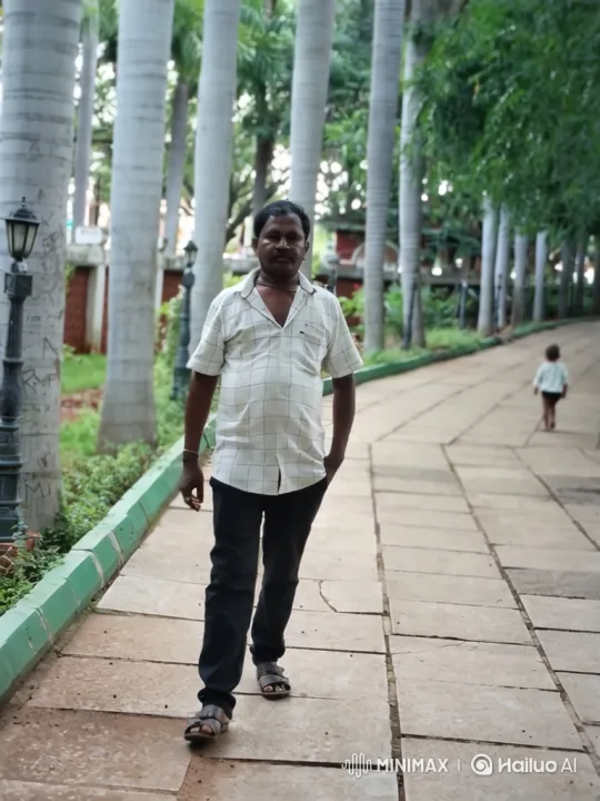 Man Walking Down Park Path Toward Camera – AI Generated Video | Hailuo AI