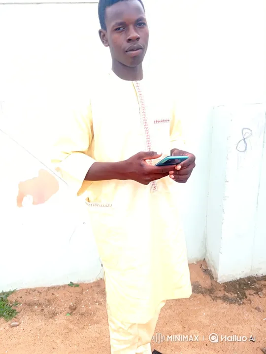 Young Man in Tunic Engages with Smartphone – AI Generated Video | Hailuo AI