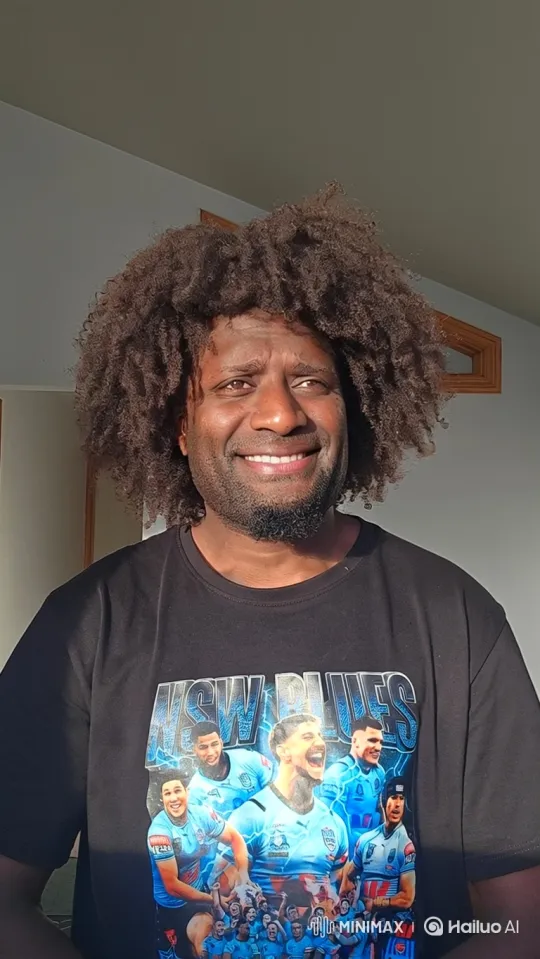 Warmly Smiling Man with Afro in Bright Indoor Setting – AI Generated Video | Hailuo AI