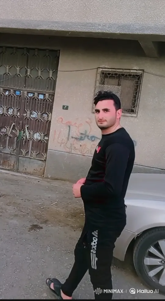 Young Man Smiles Politely at Camera on Paved Street – AI Generated Video | Hailuo AI