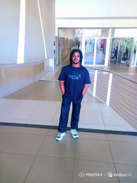 Man in Dreadlocks Walks Purposefully Down Modern Corridor – AI Generated Video | Hailuo AI