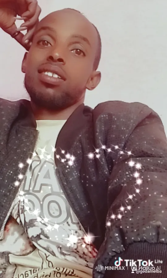 Young Man Poses with Sparkling Jacket and Friendly Smile – AI Generated Video | Hailuo AI