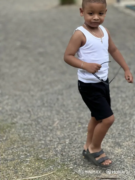 Young Boy in White Tank Top Walks Towards Camera – AI Generated Video | Hailuo AI
