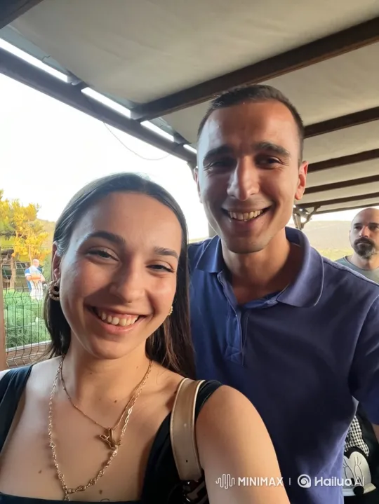 Family Love: Couple Embraces Daughter at Outdoor Gathering – AI Generated Video | Hailuo AI