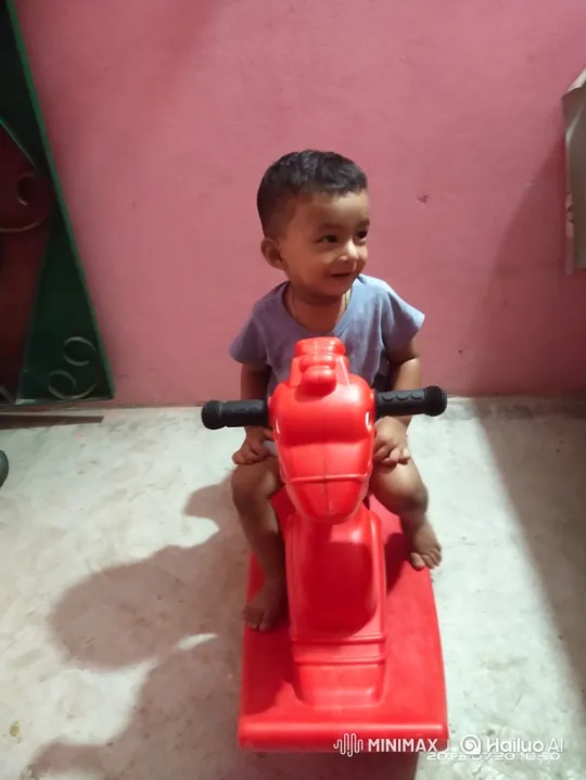 Boy Enjoys Riding a Red Plastic Rocking Horse – AI Generated Video | Hailuo AI