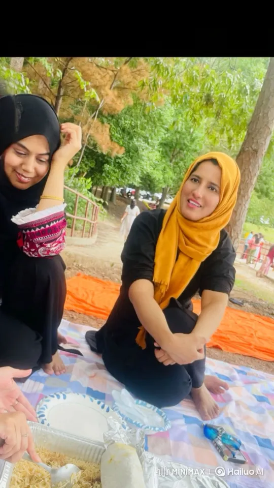 Women Enjoying Picnic and Playfully Kicking Feet – AI Generated Video | Hailuo AI