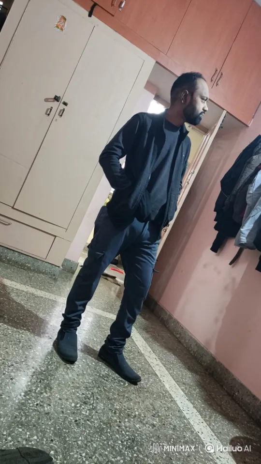 Man in Dark Jacket Stands and Turns in Static Shot – AI Generated Video | Hailuo AI