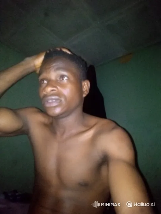 Young Man Reacts with Astonishment in Dimly Lit Room – AI Generated Video | Hailuo AI