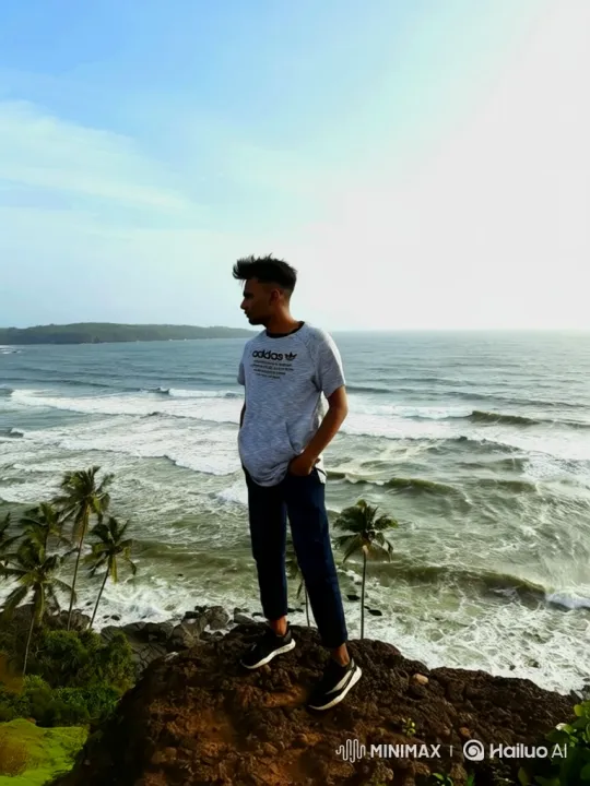 Young Man Contemplates the Sea on Rocky Cliff – AI Generated Video | Hailuo AI