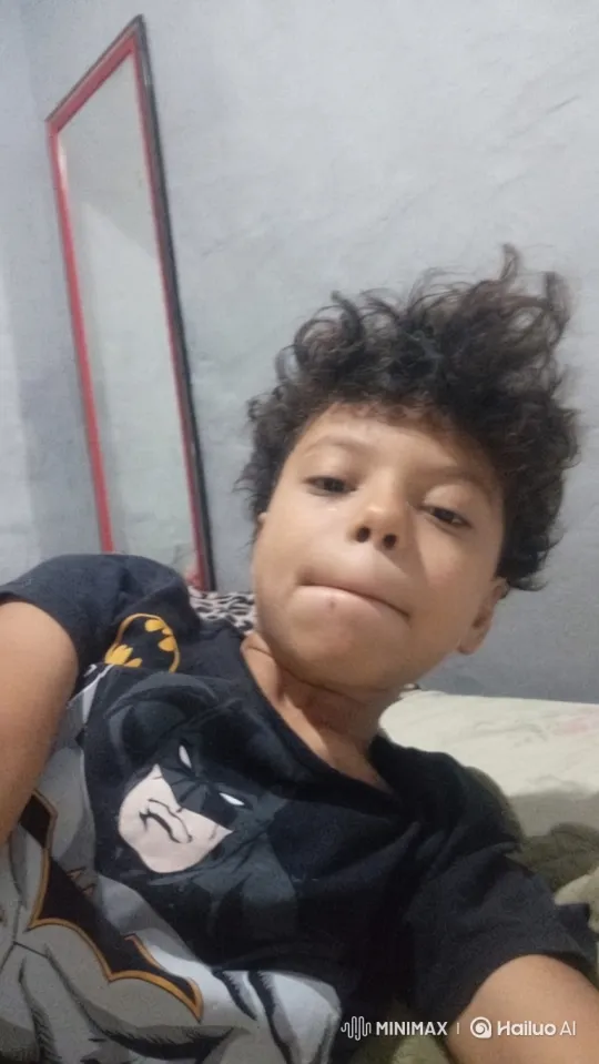 Young Boy Joyfully Jumps on Bed in Batman Shirt – AI Generated Video | Hailuo AI