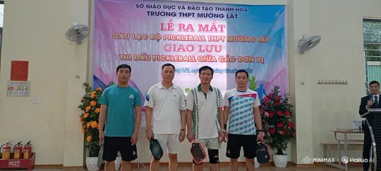 Five Men Pose with Pickleball Paddles at Indoor Event – AI Generated Video | Hailuo AI