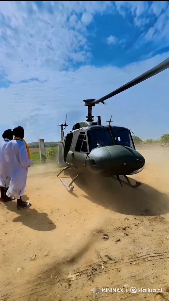 Men Rush to Board Huey Helicopter in Dusty Field – AI Generated Video | Hailuo AI