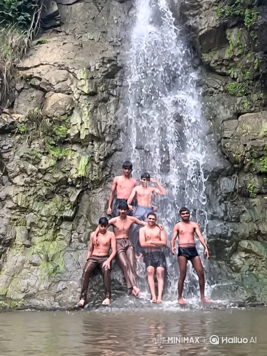 Young Men Enjoying a Splash at a Grand Waterfall – AI Generated Video | Hailuo AI