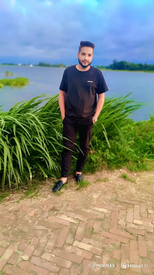 Tranquil Man by Water with Gentle Breeze and Cloudy Sky – AI Generated Video | Hailuo AI