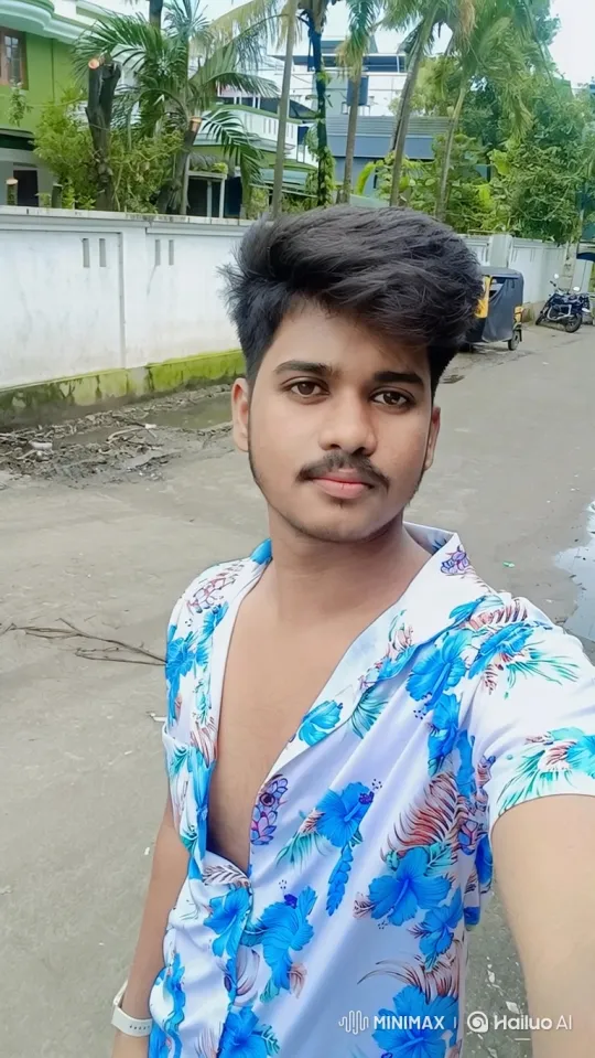 Young Man Takes Selfie in Windy Street Scene – AI Generated Video | Hailuo AI