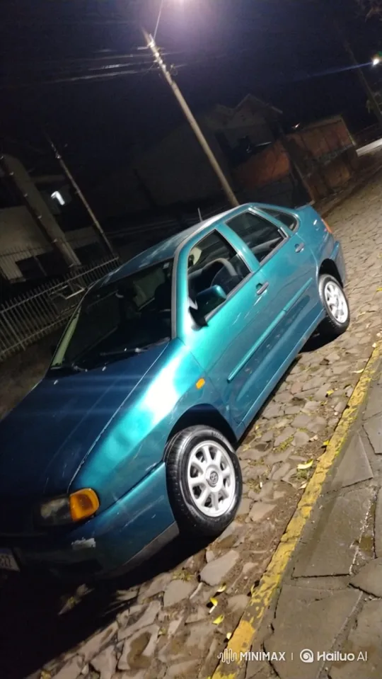 Teal Hatchback Lowering on Wet Cobblestone Street – AI Generated Video | Hailuo AI