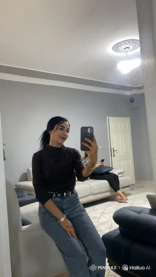 Young Woman Taking Selfie in Modern Living Room – AI Generated Video | Hailuo AI
