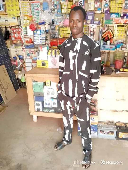 Young Man in Shop with Gradual Smile Reveal – AI Generated Video | Hailuo AI