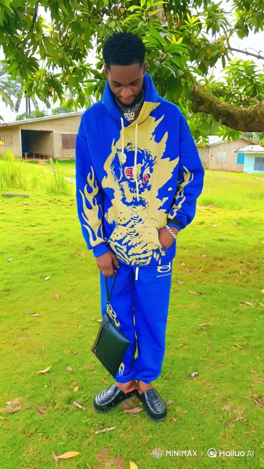 Young Man in Royal Blue Tracksuit Walks Across Lawn – AI Generated Video | Hailuo AI