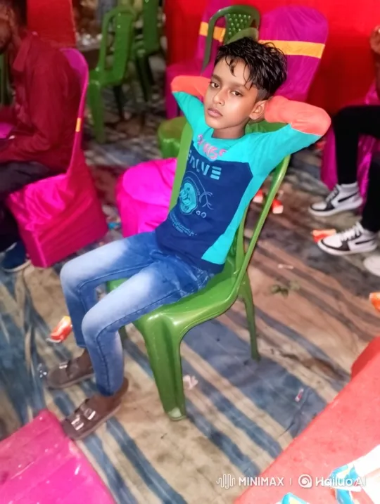 Young Boy Sitting Relaxed at Event, Staring Calmly at Camera – AI Generated Video | Hailuo AI