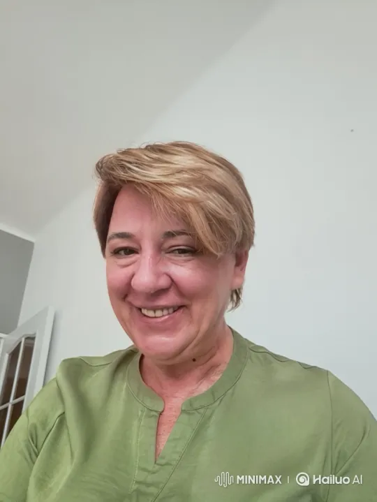 Warm, Friendly Woman in Green Blouse with Gentle Smile – AI Generated Video | Hailuo AI
