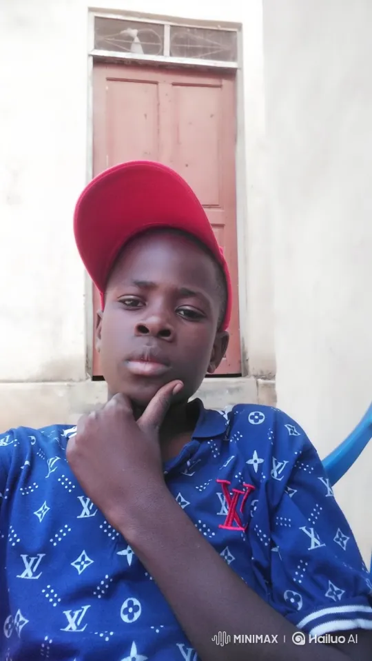 Young Boy in Red Cap Smiles Gently at Camera – AI Generated Video | Hailuo AI