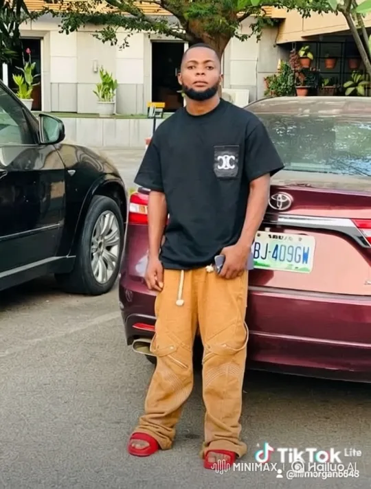 Young Man Interacts with Incoming Car in Parking Area – AI Generated Video | Hailuo AI