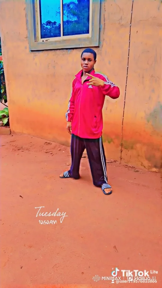 Young Man in Tracksuit Stands Confidently Before Building – AI Generated Video | Hailuo AI