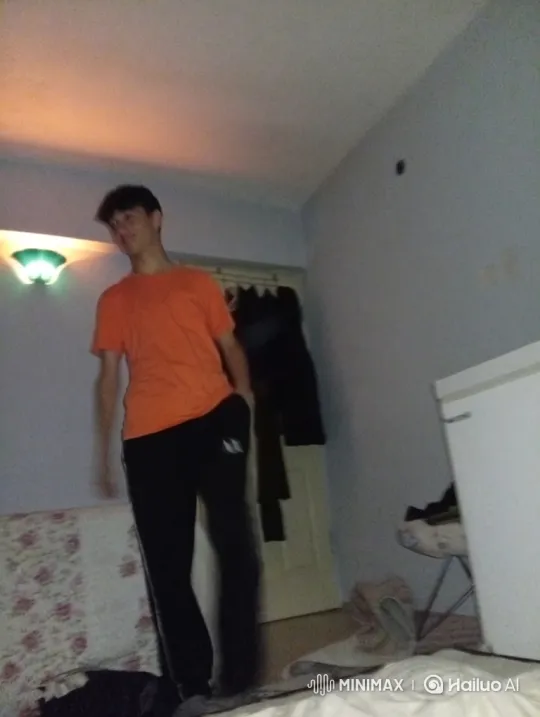 Young Man Performing Goofy Dance in Dimly Lit Room – AI Generated Video | Hailuo AI