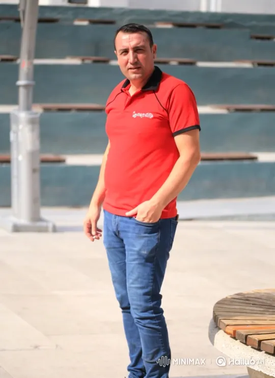 Man Smoking in Modern Plaza - Reflective Moment – AI Generated Video | Hailuo AI