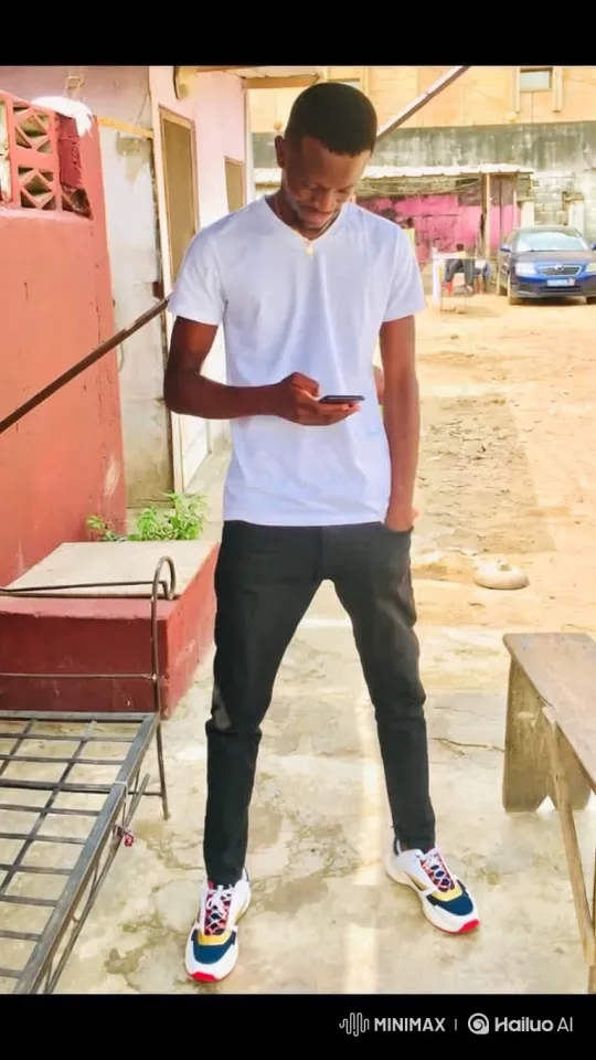 Young Man in Casual Attire Checks Phone, Smiles, and Walks Away – AI Generated Video | Hailuo AI