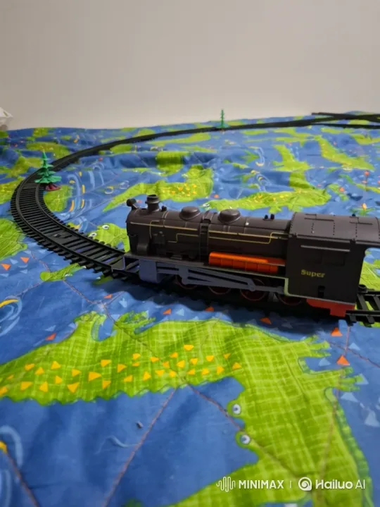 Toy Train Journey Across Patterned Blanket – AI Generated Video | Hailuo AI