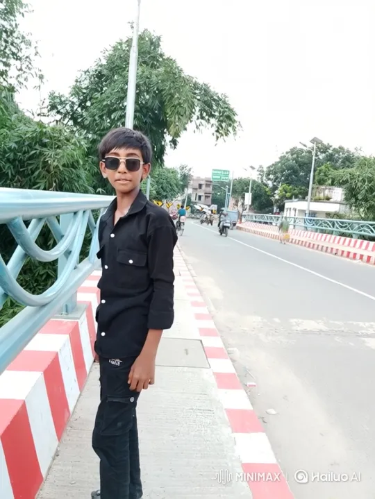 Young Boy Poses Stylishly on Bridge Sidewalk – AI Generated Video | Hailuo AI