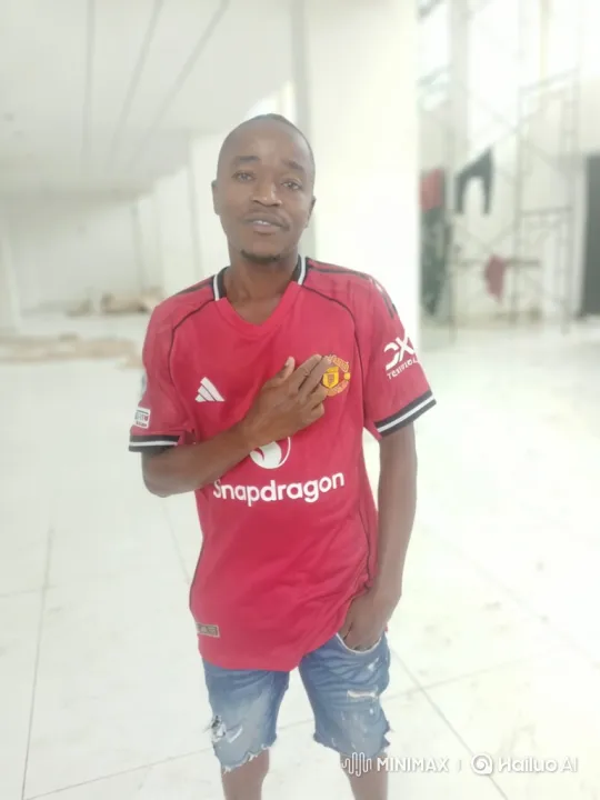 Man in Red Jersey Stands Calmly in Unfinished Building – AI Generated Video | Hailuo AI
