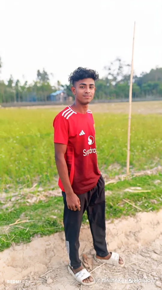 Young Man in Athletic Shirt Observes Rural Landscape – AI Generated Video | Hailuo AI