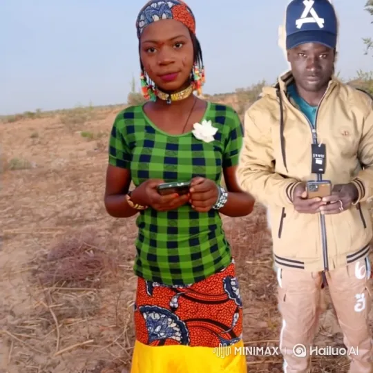 Man and woman holding phones in a dry field with a static camera – AI Generated Video | Hailuo AI