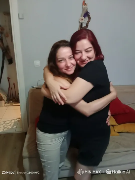 Affectionate Embrace Between Friends in Cozy Living Room – AI Generated Video | Hailuo AI