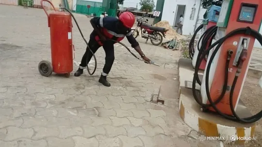 Worker Dispenses Fire Extinguishing Powder at Gas Station – AI Generated Video | Hailuo AI