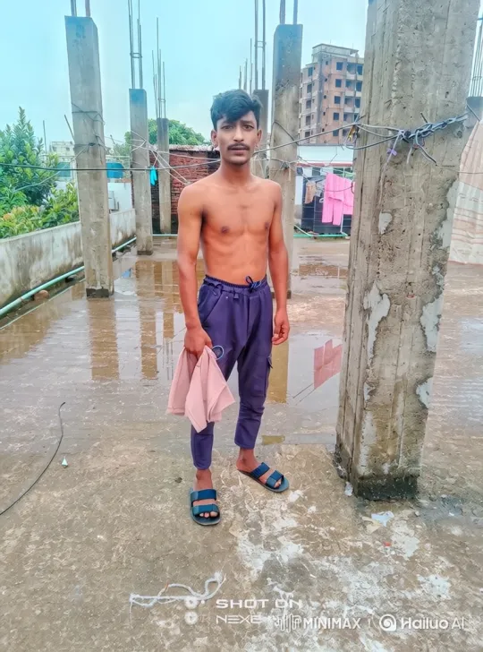 Young Man on Rooftop: Meditative Gaze and Gentle Movements – AI Generated Video | Hailuo AI