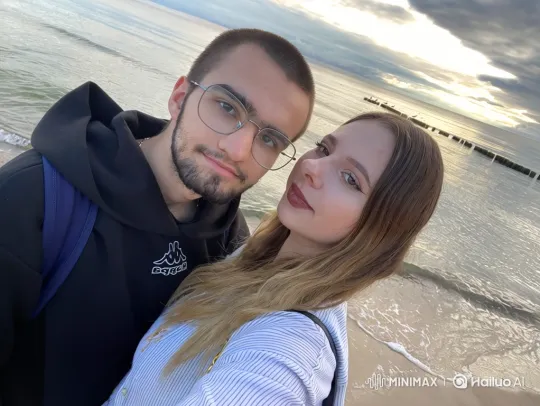 Couple and Daughter Embrace on Beach Promenade – AI Generated Video | Hailuo AI