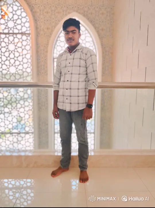 Young Man Smiles Gently in Modern Building Setting – AI Generated Video | Hailuo AI
